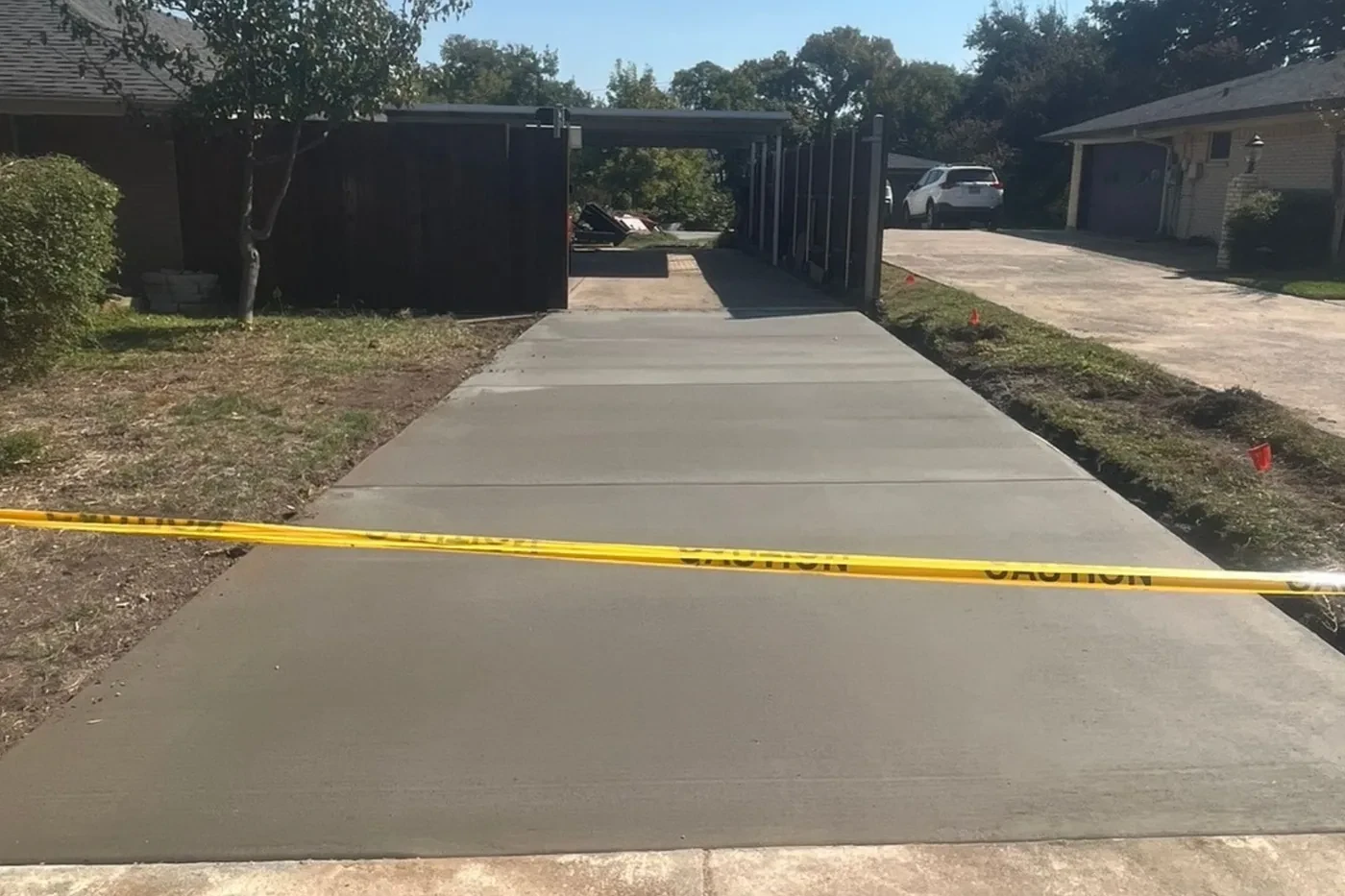 Finished wide residential concrete driveway by Lucky's Concrete
